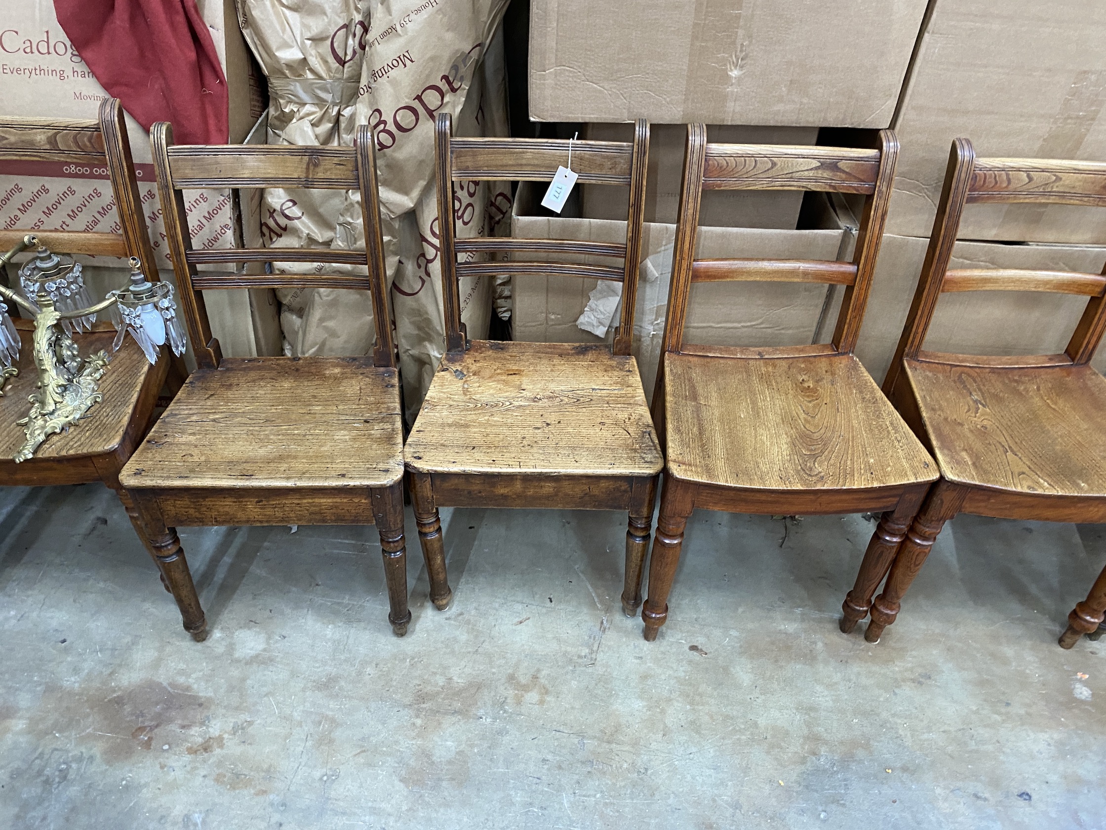 A harlequin set of nine early 19th century Provincial elm and fruitwood dining chairs